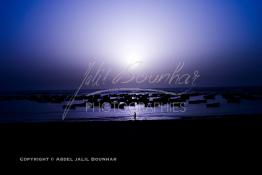 Image du Maroc Professionnelle de  Un fabuleux coucher de Soleil sur les rocher et les barques du port de Souiria Lekdima un village de pêcheurs, situé à 30 km au sud de Safi au Maroc. Ce merveilleux site réuni la mer la forêt et l'embouchure du fleuve Tensift avec l'océan Atlantique, Dimanche 12 Août 2012. (Photo / Abdeljalil Bounhar) 